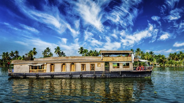 Kerala India travel background, panorama of tourist houseboat on Kerala backwaters. Kerala, India, Asia