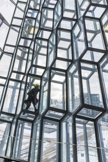 Window cleaners cleaning the glass facade of the Harpa Concert Hall and Congress Centre, interior view, Reykjanes Peninsula, Sudurnes, Iceland, Europe