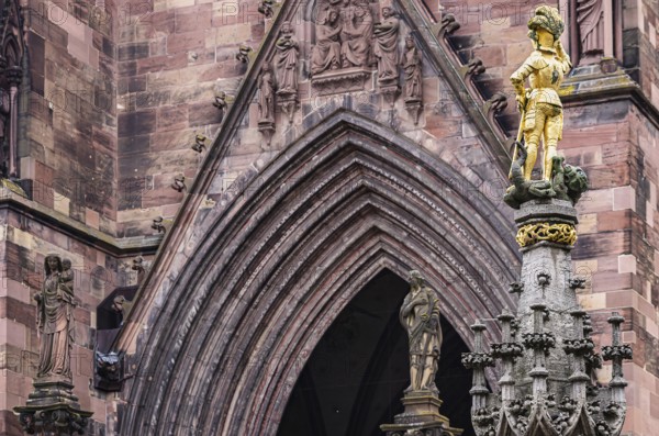 Knightly figure of St. George and details on the main portal of the Cathedral of Our Lady, Freiburg im Breisgau, Baden-Württemberg, Germany, Europe