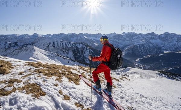 Ski tourers at the summit of Schafreuter, view of snowy mountain panorama, Karwendel, Tyrol, Austria, Europe