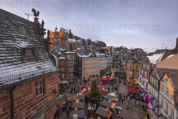 The lights at the Christmas market in Marburg's old town centre begin to glow in the evening, Wetterau, Marburg, Hesse, Germany, Europe