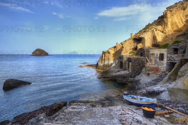 Houses in the rock, pebble beach, boat, sandstone rocks, Filicudi, Scoglio Faraglione, Spiaggia di Pollara, Pollara beach, Pollara, Salina, Aeolian Islands, Sicily, Italy, Europe