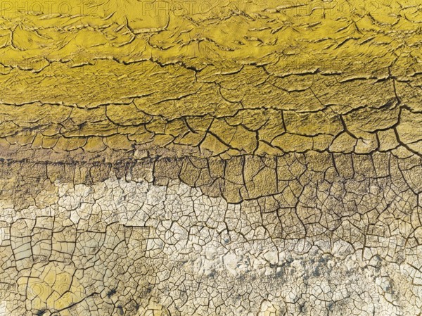 Mineral-rich cracked earth at the bank of the Rio Tinto (Red river), aerial view, drone shot, Huelva province, Andalusia, Spain, Europe