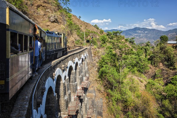 HIMACHAL PRADESH, INDIA, MAY 12, 2010: Toy train of Kalka–Shimla Railway, narrow gauge railway built in 1898 and famous for its scenery and improbable construction. It is UNESCO World Heritage Site