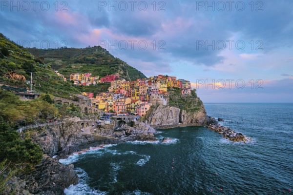 Manarola village popular european italian tourist destination in Cinque Terre National Park UNESCO World Heritage Site, Liguria, Italy on sunset