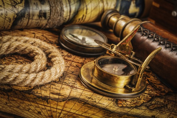 Travel geography navigation concept background, old vintage retro compass with sundial, spyglass and rope on ancient world map