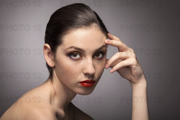 Beauty fashion girl. Portrait of beautiful young woman with fresh clean skin on grey background