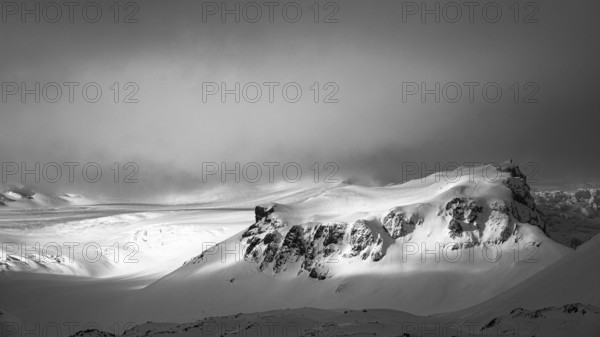 Fog, light and shadow on the snowy summit of Breidamerkurfjall, black and white photo, Sudurland, Iceland, Europe