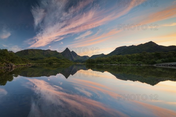 Mountains and clouds reflected in the sea, evening mood, near Stø, Langøya Island, Vesterålen, Northern Norway, Norway, Europe
