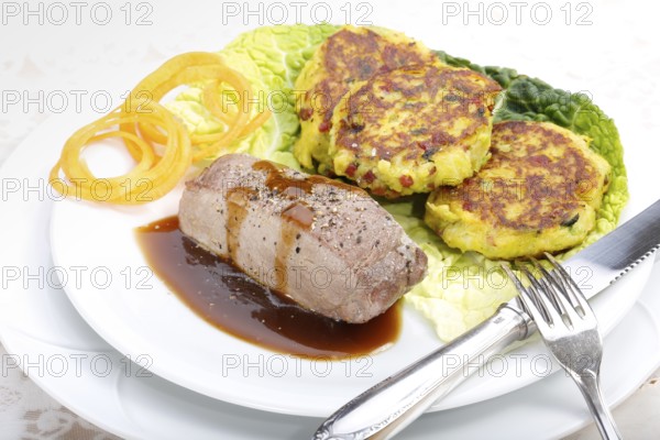 Swabian cuisine, medallions of wild boar with savoy cabbage cakes, meat dish, roasted, hearty, home cooking, typical Swabian, arranged on a plate, traditional cuisine reinterpreted, food photography, studio, Germany, Europe