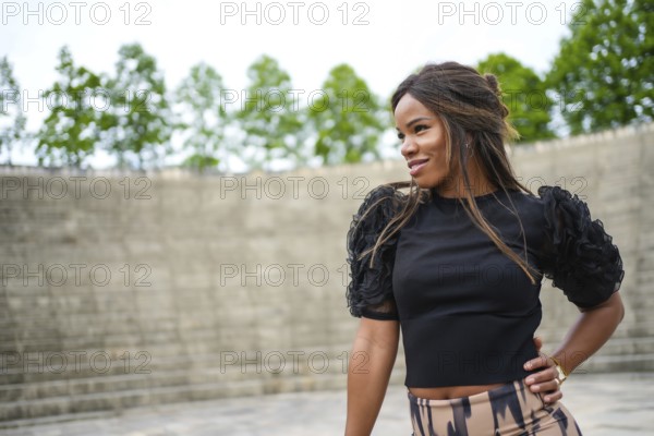Side view of a cute brunette woman dancing cuban salsa alone outdoors