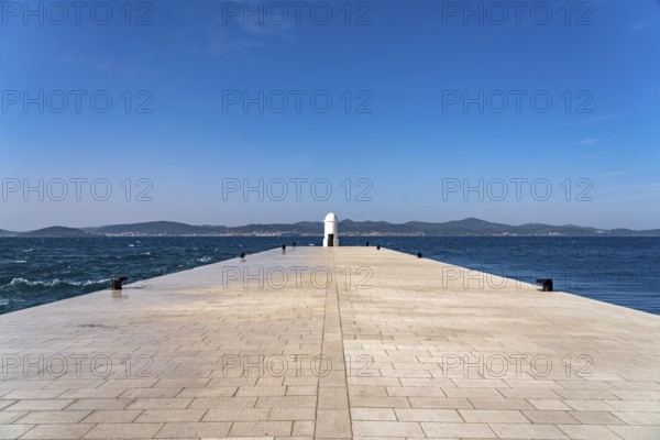 Small white lighthouse on the pier in Zadar, Croatia, Europe