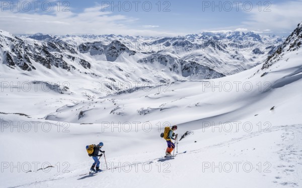 Two ski tourers in mountain landscape with snow, mountain panorama with summit of the Grisons Alps, ascent to the Scalettahorn, Grisons Haute Route, Albula Alps, Rhaetian Alps, Grisons, Switzerland, Europe