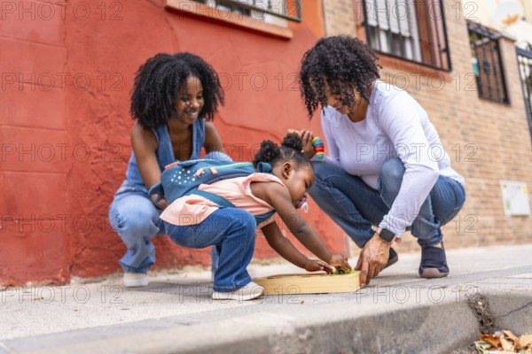African three generation woman family playing with toys in the city with baby girl