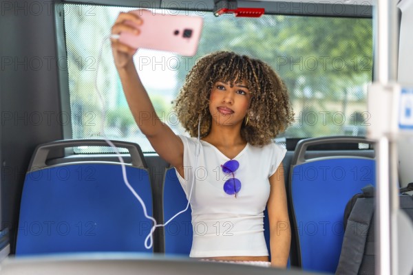 Beauty latin woman taking a selfie sitting alone in the public bus