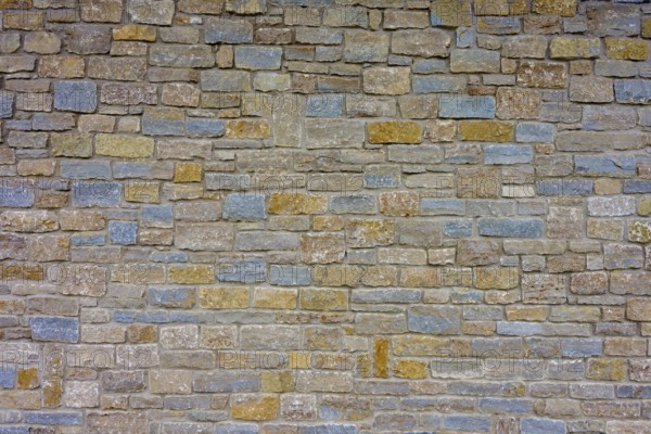 Wall made of different coloured natural stones with a subtle texture and robust appearance, Würzburg, Bavaria, Germany, Europe