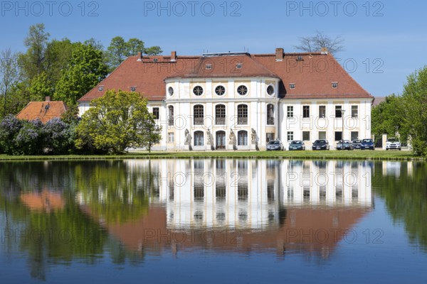 Baroque castle with reflection in the large pond, Königswartha, Upper Lusatia, Saxony, Germany, Europe