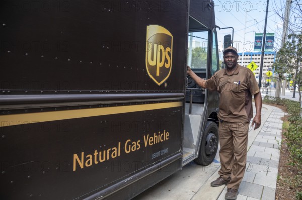 New Orleans, Louisiana - A United Parcel Service driver and his natural gas powered 'package car' at the New Orleans Convention Center