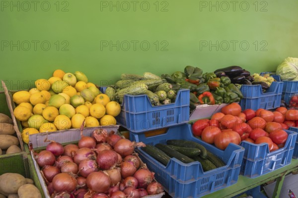 Market stall with various types of fruit and vegetables such as lemons, potatoes, onions, tomatoes, cucumbers, peppers, Symi Island, Dodecanese, Greece, Europe