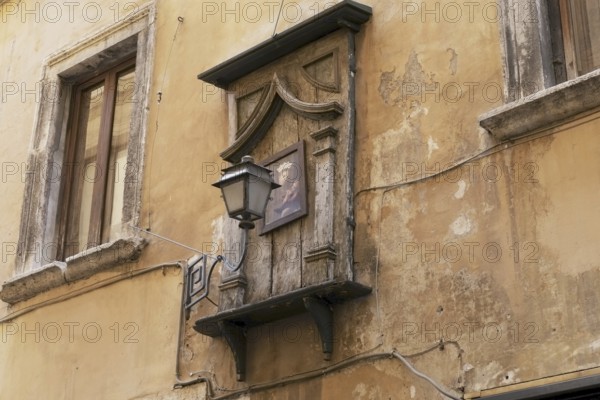 Madonna painting with a lantern in front on a house in the historic centre of Rome, Italy, Europe