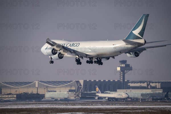 Cathay Pacific Boeing 747-8F cargo aircraft approaching Frankfurt FRA airport, air traffic control tower, Fraport, in winter, Hesse, Germany, Europe