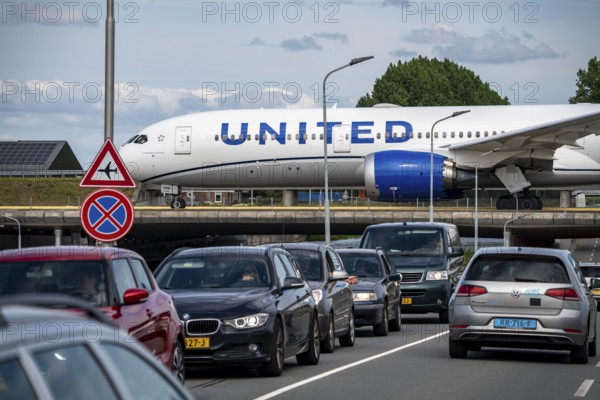 Amsterdam Schiphol Airport, United Jet, on the taxiway, to the Polderbaan runway, bridge over a road and a canal, Amsterdam, Netherlands
