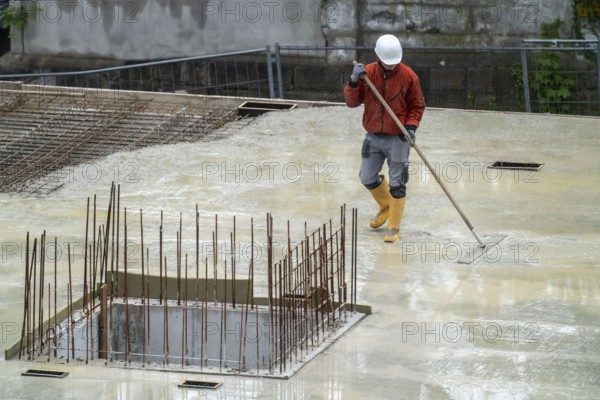 Construction site, concreting, the floor slab of a building is concreted, the fresh concrete is levelled