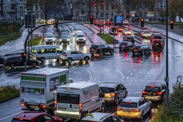 Rainy weather, road traffic, intersection, lights of vehicles on a wet road, traffic lights, tail lights, headlights, symbolic image