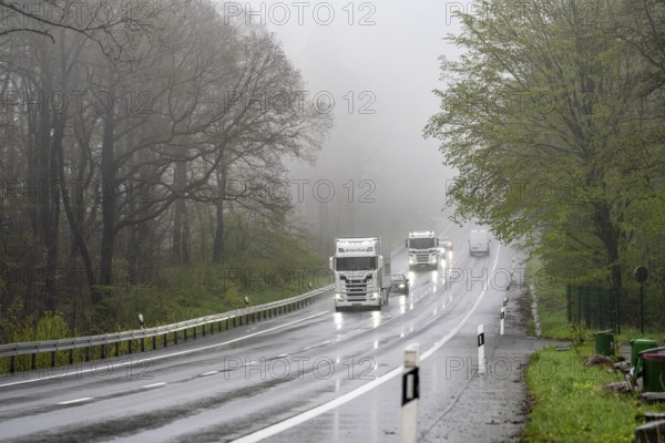 Traffic on a country road in the rain, B229, spring, near Radevormwalde, Oberbergischer Kreis, North Rhine-Westphalia, Germany, Europe