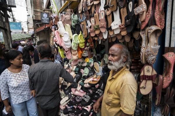 A vendor sells shoes and sandals at a street market ahead of Durga Puja festival on October 7, 2024 in Guwahati, India. Shopping ahead of Durga Puja is a major event, as people prepare for the celebration