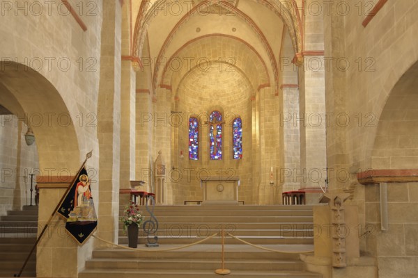 Chancel of the Romanesque Basilica of St. Lubentius, flag of St. Lubentius, interior view, colourful church windows, Dietkirchen, Limburg, Hesse, Germany, Europe