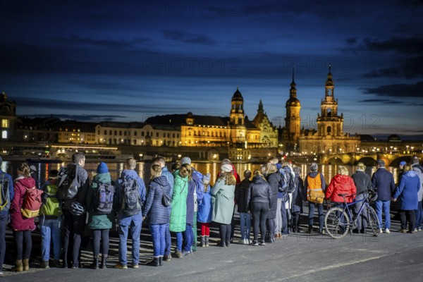 On 13 and 14 February 1945, Dresden was heavily destroyed in three Allied bombing raids. Every year, the people of Dresden commemorate this event at various events. A long human chain symbolised the protection of the city centre. Here looking from the Königsufer across the Elbe to the Old Town, Dresden, Saxony, Germany, Europe