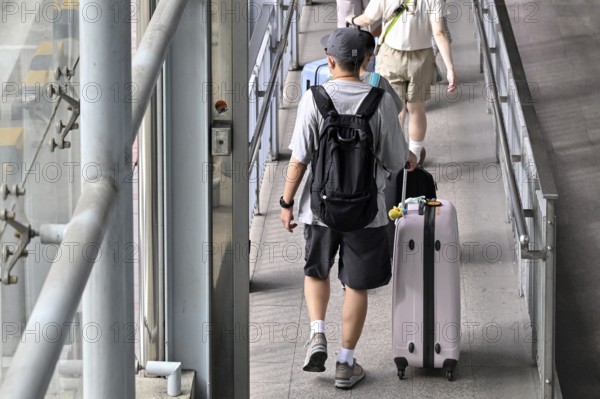 Tourist with trolley case