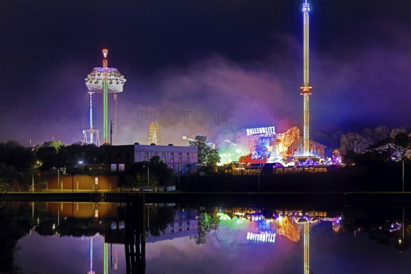 Rhine-Herne Canal with the Cranger Kirmes at night on the other side of the canal, Herne, Ruhr Area, North Rhine-Westphalia, Germany, Europe