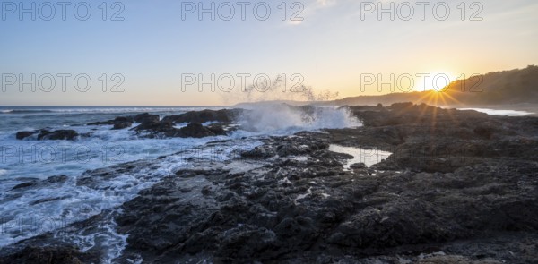 Waves crashing against rocks, Playa Cocalito, coastal landscape at sunset, sun star, Pacific coast, Nicoya Peninsula, Puntarenas province, Costa Rica, Central America