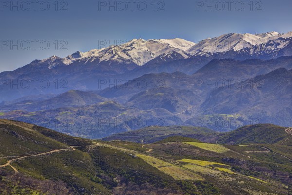 Mountain landscape with snow-covered peaks, green hills and windy paths, Lefka Ori, White Mountains, mountain massif, west, Crete, Greece, Europe