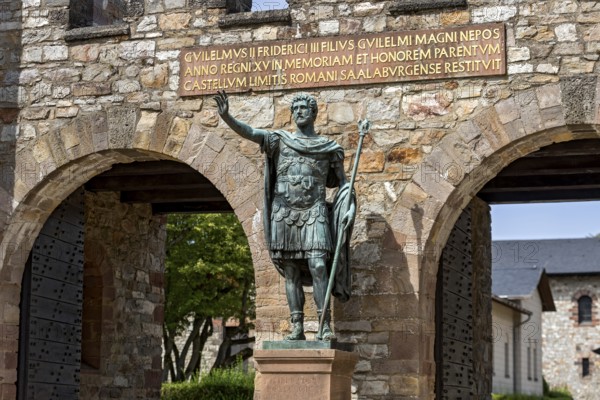 Main gate, Porta Praetoria with bronze statue of Emperor Antoninus Pius, plaque with inscription for Wilhelm II, Saalburg Roman fort, reconstructed cohort fort, museum, archaeological park, Upper Germanic Raetian Limes, border of the Roman Empire, Bad Homburg vor der Höhe, Taunus, Hesse, Germany, Europe