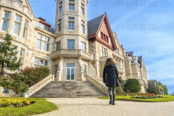A tourist walking in the Magdalena Palace in the city of Santander, Spain, Europe