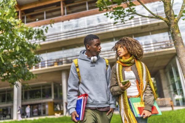 Multiethnic students walking out the university campus in a sunny day of autumn