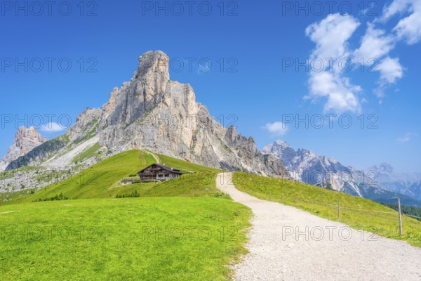 Scenic view of idyllic valley with hiking trail leading to refuge at the foot of majestic nuvolau mountain range in the heart of italian dolomites