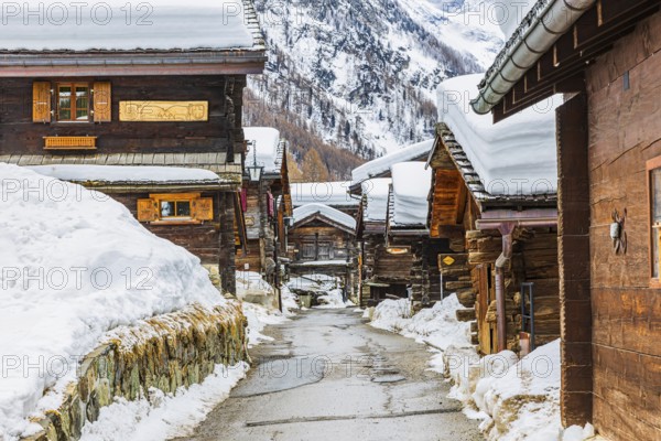 Street with historic old snow-covered wooden houses, mountain village of Zinal, Val d'Anniviers, Valais Alps, Canton Valais, Switzerland, Europe