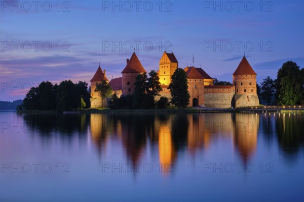 Night view of Trakai Island Castle in lake Galve illuminated in the evening, Lithuania, Europe