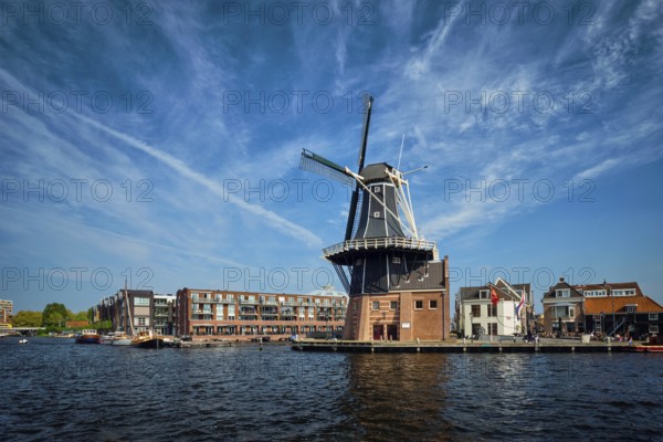 View of Harlem landmark windmill De Adriaan on Spaarne river. Harlem, Netherlands