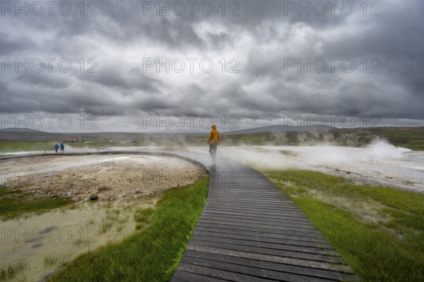 Tourist on a wooden path, steaming hot springs, Hveravellir geothermal area, Icelandic highlands, Suðurland, Iceland, Europe