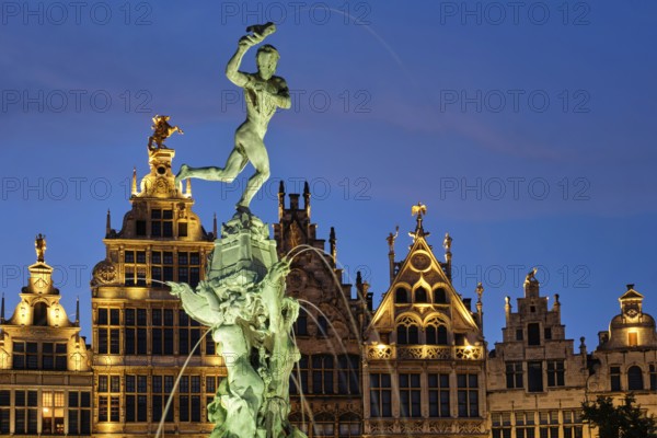 Antwerp famous Brabo statue and fountain on Grote Markt square illuminated at night and old houses. Antwerp, Belgium, Europe