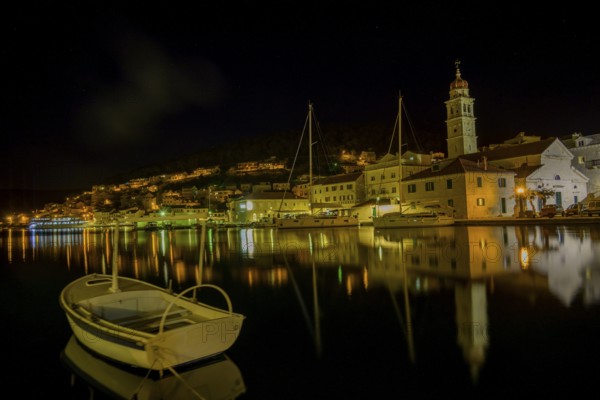 Church of St. Jerome of Stridon with rowing boat and sailboats at night, Pucišca, Split-Dalmatia County, Croatia, Europe