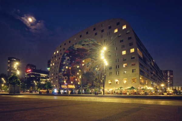 ROTTERDAM, NETHERLANDS, MAY 25, 2018: Markthal Market Hall residential and office building with a market hall underneath in Rotterdam designed by by architectural firm MVRDV illuminated in night