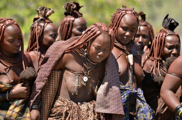 Mourning Himba women at a funeral, the widow in the middle, Omohanja, Kaokoland, Kunene, Namibia, Africa