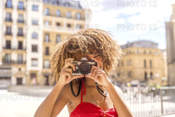 Cute cool and beauty brunette woman taking a photo and smiling visiting a city