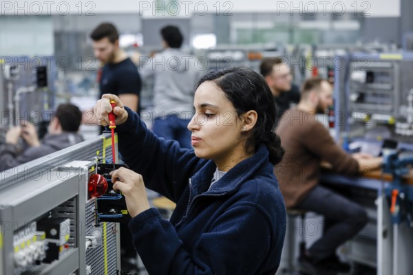 Remscheid, North Rhine-Westphalia, Germany - Trainee woman in electrical professions, an industrial electrician assembles a circuit, Vocational Training Centre of the Remscheid Metal and Electrical Industry. - FOR EDITORIAL USE ONLY!